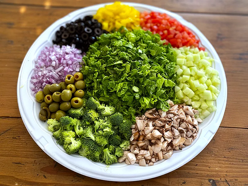 Garden vegetable tray with lettuce, olives, cucumbers, mushrooms